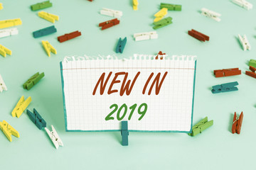 Text sign showing New In 2019. Business photo showcasing what will be expecting or new creation for the year 2019 Colored clothespin papers empty reminder blue floor background office pin