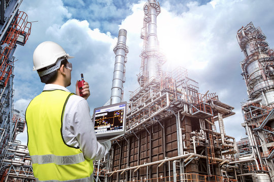Double exposure of engineers holding walkie talkie are working orders the oil and gas refinery plant. Industry concept image.