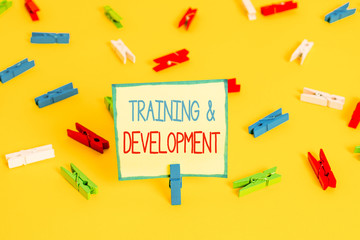 Text sign showing Training And Development. Business photo text learn specific knowledge to improve perforanalysisce Colored clothespin papers empty reminder yellow floor background office