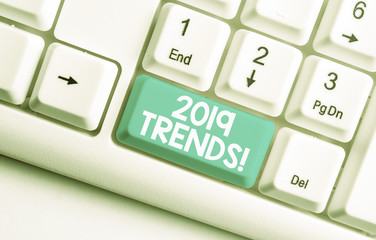 Conceptual hand writing showing 2019 Trends. Concept meaning general direction in which something is developing or changing White pc keyboard with note paper above the white background