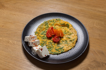 Egg omelet served on black plate