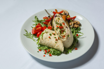 Wrapped tortilla served on plate