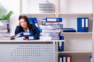 Middle-aged businesswoman unhappy with excessive work
