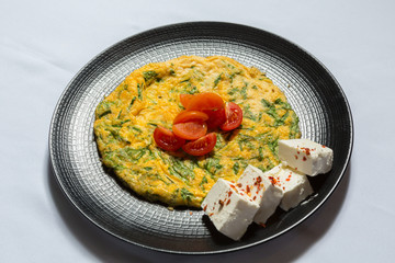 Egg omelet served on black plate