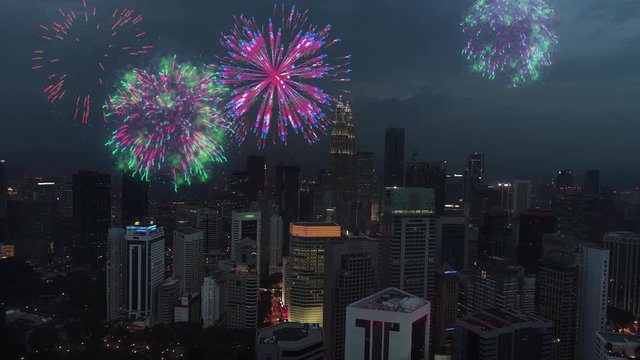 Aerial view bright shining fireworks explode in the cloudy sky