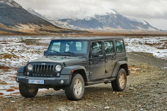HOFFEL, ICELAND - MAY 03, 2018: Jeep Wrangler Unlimited four wheel drive vehicle on Icelandic landscape, snow in background