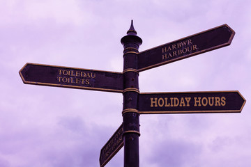 Fototapeta premium Word writing text Holiday Hours. Business photo showcasing employee receives twice their normal pay for all hours Road sign on the crossroads with blue cloudy sky in the background