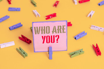 Word writing text Who Are You Question. Business photo showcasing asking about someone identity or demonstratingal information Colored clothespin papers empty reminder yellow floor background office