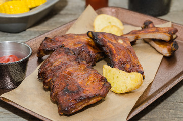 Smoked barbecue pork spare ribs and rustic fries