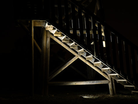  lights and shadows of wooden stairs of a fire watch tower