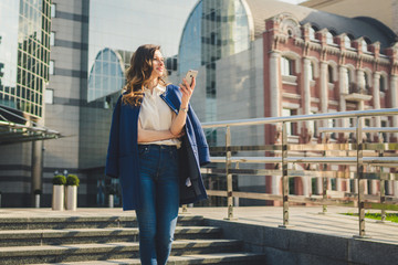 Office buildings city people in suit. Caucasian businesswoman using smartphone with hand. Business...