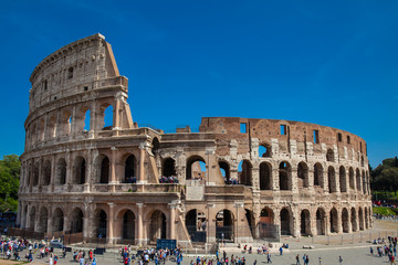 Obraz premium Tourists visiting the famous Colosseum in Rome in a beautiful early spring day