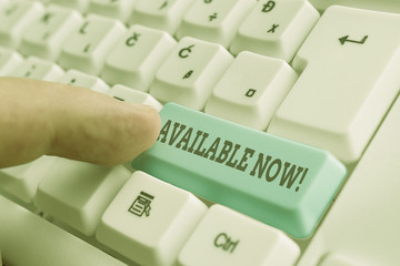 Conceptual hand writing showing Available Now. Concept meaning you can find it obtain or operable at this current moment White pc keyboard with note paper above the white background