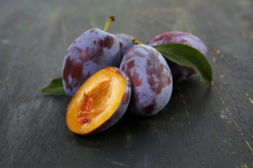 fresh blue plums on a dark background