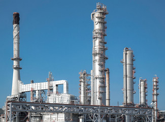 Close-up view Oil and gas industrial refinery zone,Detail of equipment oil pipeline steel with valve from large oil storage tank at cloudy sky. -image