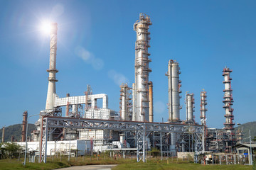 Close-up view Oil and gas industrial refinery zone,Detail of equipment oil pipeline steel with valve from large oil storage tank at cloudy sky. -image