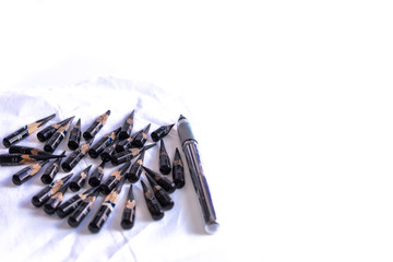 Many short pencils used  on paper on the table