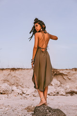 Fototapeta premium beautiful young boho style woman on the beach at sunset