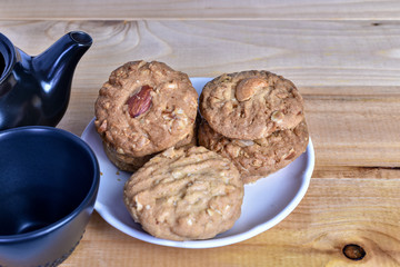 Pile of Delicious Almond Cookies on a White Plate and hot Chinese tea