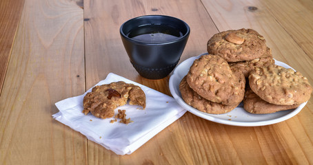 Pile of Delicious Almond Cookies on a White Plate and hot Chinese tea