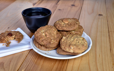 Pile of Delicious Almond Cookies on a White Plate and hot Chinese tea