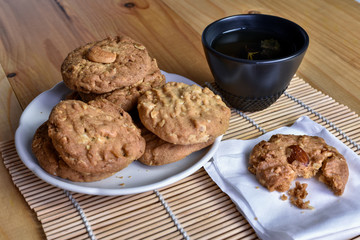 Pile of Delicious Almond Cookies on a White Plate and hot Chinese tea
