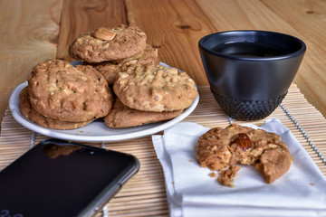 Pile of Delicious Almond Cookies on a White Plate and hot Chinese tea