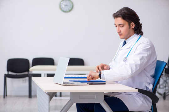 Young handsome doctor working in the clinic