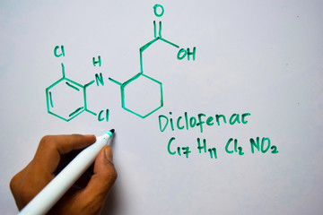 Diclofenac (C17,H11,CI2,NO2) molecule written on the white board. Structural chemical formula. Education concept