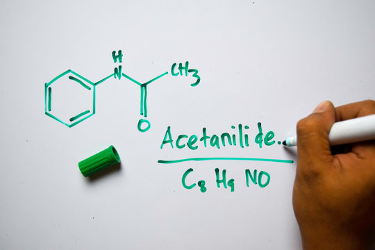 Acetanilide (C8,H9,NO) molecule written on the white board. Structural chemical formula. Education concept