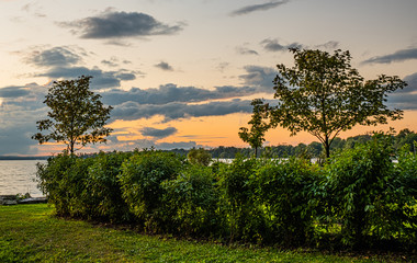 Sunset at Clardon Beach Georgina Ontario, with great view of the lake, trees, stones, clouds, and light