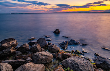 Sunset at Clardon Beach Georgina Ontario, with great view of the lake, trees, stones, clouds, and light