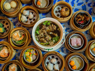 Traditional chinese dim sum steamed dumplings in the wooden plate on the table.