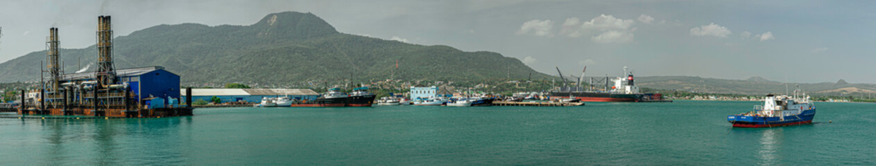 Electrical power station in Puerto Plata harbor, port industrial panoramic view, ships, boats,...