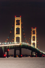 Fototapeta na wymiar The Mackinac Bridge fully illuminated on a moonlit night