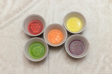 multi-colored sweets dissolve in water, all paints and harmful substances fall into the water, it is dangerous for children and for humans