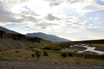Grass Field and mountains at dramatic overcast sky in Kazakhstan, central Asia