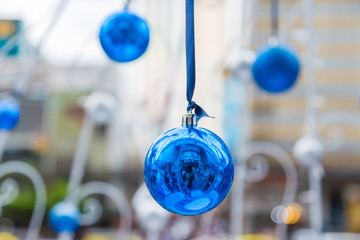 Christmas balls hanging on ribbon with bokeh