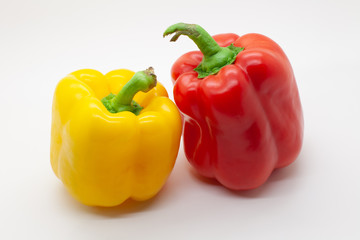 Red and yellow sweet bell pepper on a white background, selective focus