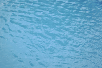 Fototapeta na wymiar Blue swimming pool edge with refection of water ripple