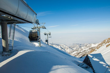 high snowy mountains in cloudy day, mounting skiing resort Shymbulak or Chimbulak, Almaty, Kazakhstan