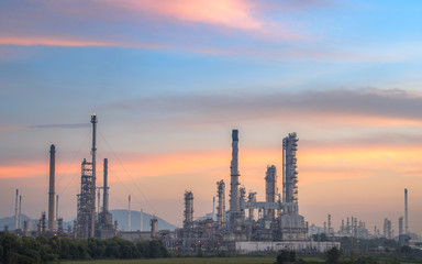 Oil and gas refinery plant form industry petroleum zone,Refinery equipment pipeline steel and oil storage tank at sunrise. -image