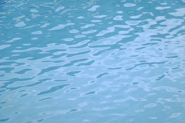 Blue swimming pool edge with refection of water ripple