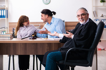 Young couple in the courthouse in divorce concept