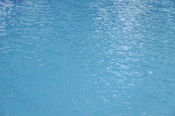 Blue swimming pool edge with refection of water ripple