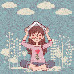 Cute, little girl with book in the garden