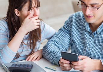 Young couple looking at family finance papers