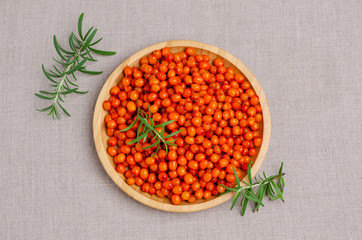 Large sea buckthorn berries with rosemary branches.
