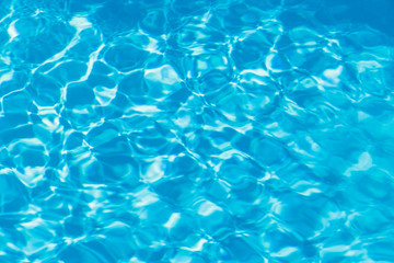 Blue pool water with sun reflections