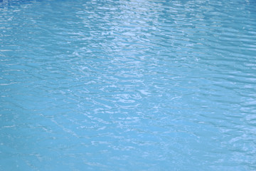 Blue swimming pool edge with refection of water ripple